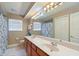 Shared bathroom with double vanity and shower/tub combo at 4077 Greystone Dr, Clermont, FL 34711