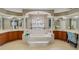 Luxurious Primary bathroom featuring a large soaking tub and double vanity at 4077 Greystone Dr, Clermont, FL 34711