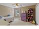 Cozy bedroom with dresser, bookshelf, and twin-size bed at 4077 Greystone Dr, Clermont, FL 34711