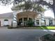 Elegant clubhouse entrance with landscaping at 4077 Greystone Dr, Clermont, FL 34711