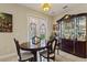 Elegant dining room with a formal dining set and a built-in hutch at 4077 Greystone Dr, Clermont, FL 34711