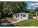 Landscaped backyard with patio and storage shed at 4110 Close Ct, Mount Dora, FL 32757