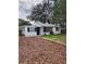 Cute ranch home with a white exterior and a neatly landscaped yard at 4110 Close Ct, Mount Dora, FL 32757