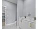 Modern bathroom with double vanity, marble floors, and walk-in shower at 42025 Royal Trails Rd, Eustis, FL 32736