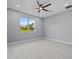 Bright bedroom featuring a large window and ceiling fan at 42025 Royal Trails Rd, Eustis, FL 32736