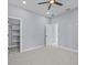 Spacious bedroom with carpeted floor, ceiling fan, and walk-in closet at 42025 Royal Trails Rd, Eustis, FL 32736