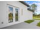 White house exterior with french doors leading to a patio at 42025 Royal Trails Rd, Eustis, FL 32736