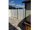 Backyard stone paver patio with white vinyl privacy fence, and partial view of the hot tub at 4556 Water Oak Ter, Oxford, FL 34484