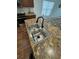 Double stainless steel sink on a granite countertop kitchen island, in a home with hardwood floors at 4556 Water Oak Ter, Oxford, FL 34484