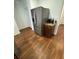 Modern stainless steel refrigerator next to wooden cabinets, hardwood floors, and a light-filled entryway at 4556 Water Oak Ter, Oxford, FL 34484