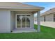 Covered patio features sliding glass door, view of backyard, and seamless indoor-outdoor living at 5119 Firebush Dr, Apopka, FL 32712