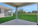 View from covered patio, showcasing the expansive grassy backyard, and the surrounding serene landscape at 5119 Firebush Dr, Apopka, FL 32712
