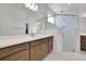 Bathroom features a large glass shower, double sink and white countertops at 5119 Firebush Dr, Apopka, FL 32712
