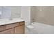Modern bathroom with a white vanity, neutral tiled walls, and bathtub with shower, offering a clean aesthetic at 5119 Firebush Dr, Apopka, FL 32712