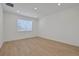 Bright bedroom features light-toned wood flooring and a window at 5119 Firebush Dr, Apopka, FL 32712