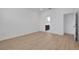 Bright bedroom with wood-look flooring features an en-suite bathroom and a large closet at 5119 Firebush Dr, Apopka, FL 32712