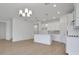 Open concept view of the kitchen and living room, flooded with natural light at 5119 Firebush Dr, Apopka, FL 32712