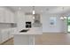 The open kitchen is equipped with an island, stainless steel appliances, and lots of light at 5119 Firebush Dr, Apopka, FL 32712