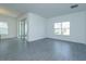 Spacious living area with sliding glass doors and gray tile floors at 5119 Firebush Dr, Apopka, FL 32712