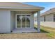 Covered patio with sliding glass doors offers great views of the home's spacious outdoor area at 5119 Firebush Dr, Apopka, FL 32712
