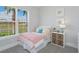 Cozy bedroom with large window, a full-size bed, and plenty of natural light at 5121 Blanket Flower St, Apopka, FL 32712