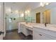 Elegant bathroom boasts double vanity, marble shower, and modern fixtures at 5155 Firebrush Dr, Apopka, FL 32712