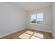 Well-lit bedroom with large window and wood flooring at 5155 Firebrush Dr, Apopka, FL 32712