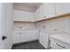 Laundry room with white cabinets and quartz countertops at 5155 Firebrush Dr, Apopka, FL 32712