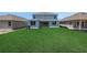 The home features a well-maintained backyard with lush green grass, offering a serene outdoor space at 5155 Firebush Dr, Apopka, FL 32712