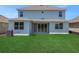 The home features a well-maintained backyard with lush green grass, offering a serene outdoor space at 5155 Firebush Dr, Apopka, FL 32712