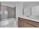 Bathroom features a shower-tub combo with marble tile and modern vanity at 5155 Firebush Dr, Apopka, FL 32712