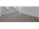 Empty bedroom with carpeting, light walls and a pair of windows at 5155 Firebush Dr, Apopka, FL 32712