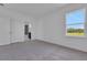 Bedroom featuring carpet, bathroom access, and natural light from window at 5155 Firebush Dr, Apopka, FL 32712