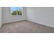 Bedroom with plush carpet and a window view to the backyard at 5155 Firebush Dr, Apopka, FL 32712