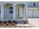 The home boasts a welcoming front porch with classic architectural details, enhancing curb appeal at 5155 Firebush Dr, Apopka, FL 32712