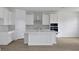This kitchen features white cabinets, stainless steel appliances, and a large island at 5155 Firebush Dr, Apopka, FL 32712