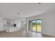 The home features an open living space with a sliding glass door to the backyard view with a view of the kitchen at 5155 Firebush Dr, Apopka, FL 32712