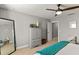 Bright bedroom with ceiling fan, large mirror, and ample closet space at 5448 Via Appia Way, Sanford, FL 32771