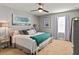 Bedroom with king bed, teal blanket, and large artwork at 5448 Via Appia Way, Sanford, FL 32771