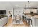 Open concept dining area with a farmhouse table and adjacent kitchen at 5448 Via Appia Way, Sanford, FL 32771