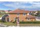 Rear view of a two-story townhome with a screened enclosure and well-maintained landscaping at 5448 Via Appia Way, Sanford, FL 32771