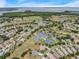 Aerial view of Royal Harbor, showcasing homes, lake, tennis courts, and community center at 5502 Bounty Cir, Tavares, FL 32778