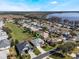 Aerial view showing home and neighborhood near lake at 5502 Bounty Cir, Tavares, FL 32778