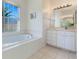 Clean bathroom featuring a bathtub, vanity, and window at 5502 Bounty Cir, Tavares, FL 32778