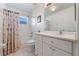 Bathroom with shower, vanity, and patterned curtain at 5502 Bounty Cir, Tavares, FL 32778