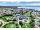 Aerial view of community center, pool, tennis courts, and lake at 5502 Bounty Cir, Tavares, FL 32778