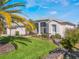 Well-maintained single-story home with manicured lawn, mature shrubbery and a screened porch at 5502 Bounty Cir, Tavares, FL 32778