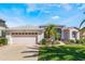 Charming single-story home with a two-car garage and a beautifully landscaped front yard with tropical plants at 5502 Bounty Cir, Tavares, FL 32778