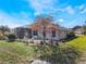 Single-story house with landscaped yard and screened patio at 5502 Bounty Cir, Tavares, FL 32778