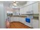 Well-equipped kitchen featuring white cabinets and granite countertops at 5502 Bounty Cir, Tavares, FL 32778